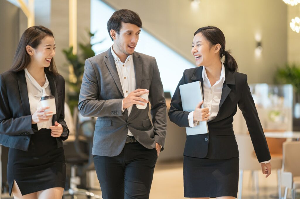 Businessman and businesswoman talking when walking